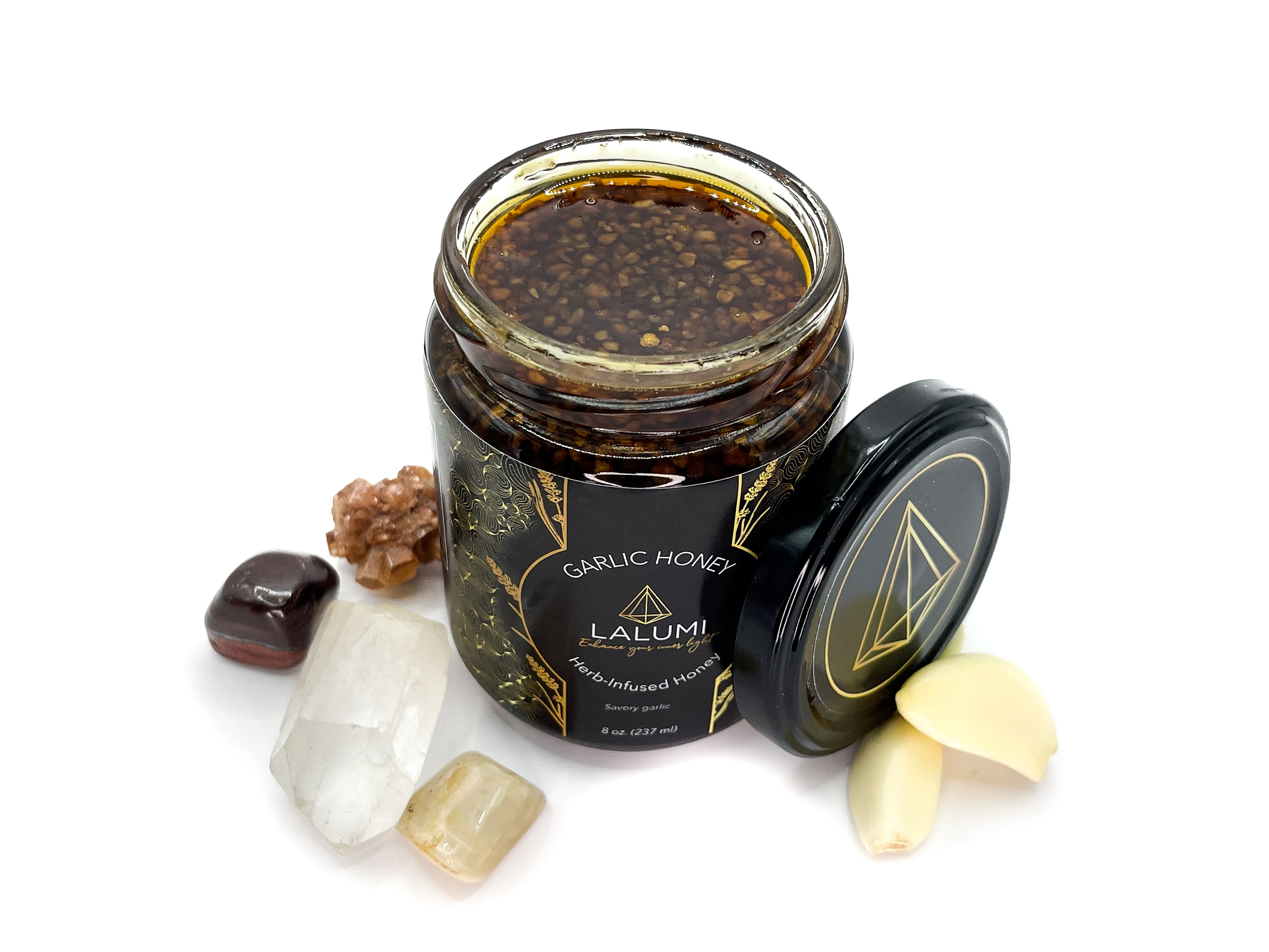 Image of Top view of 8 oz jar of Organic Garlic Infused Local Honey by LaLumi Herbes on a white background