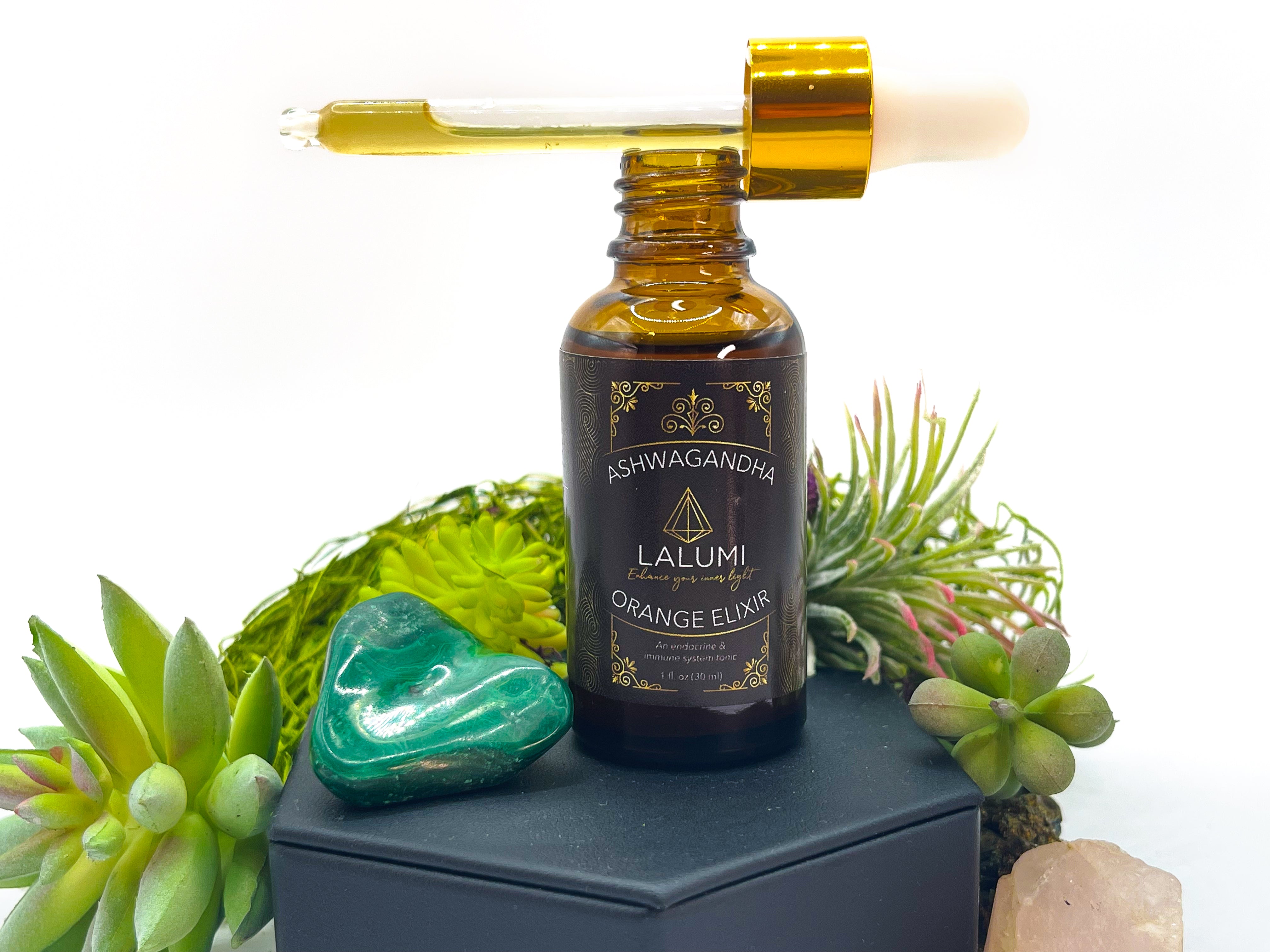 Image of 1 oz bottle of Organic Ashwagandha Orange Elixir by LaLumi Herbes
with a dropper on a white background