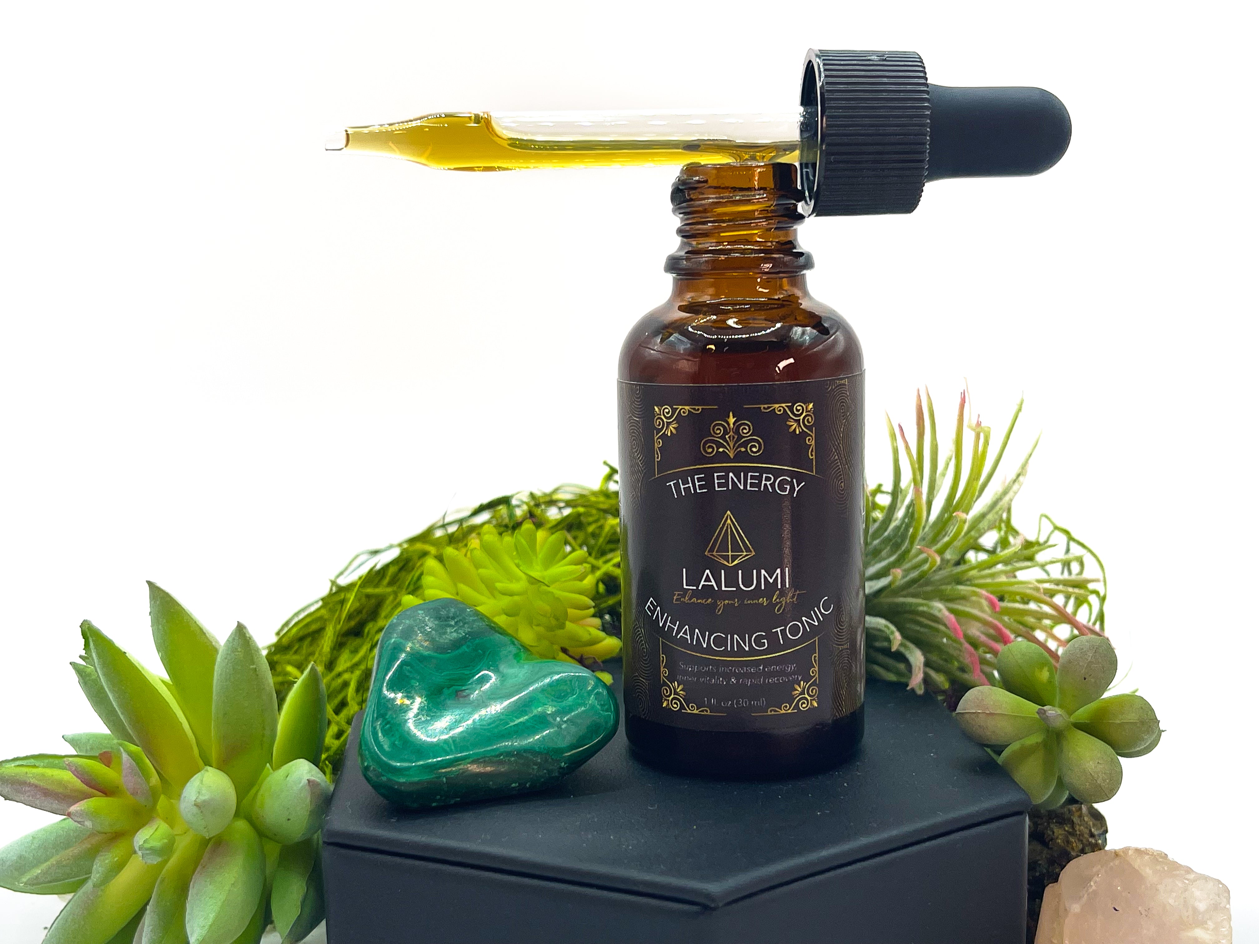 Image of 1 oz bottle of Energy-Enhancing Herbal Tonic by LaLumi Herbes with a dropper on a white background