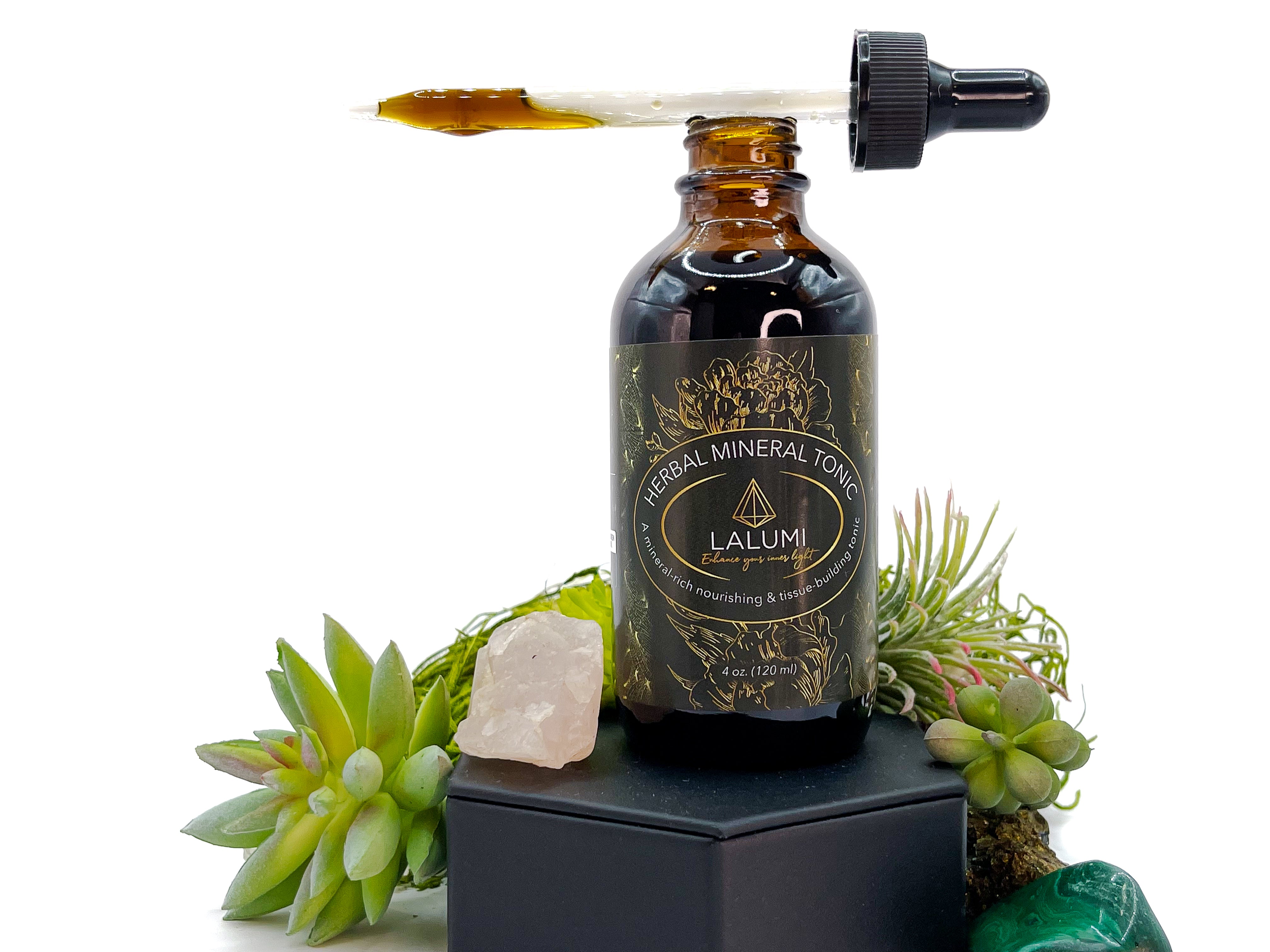 Image of 4 oz bottle of Herbal Mineral Tonic by LaLumi Herbes with a dropper on a white background