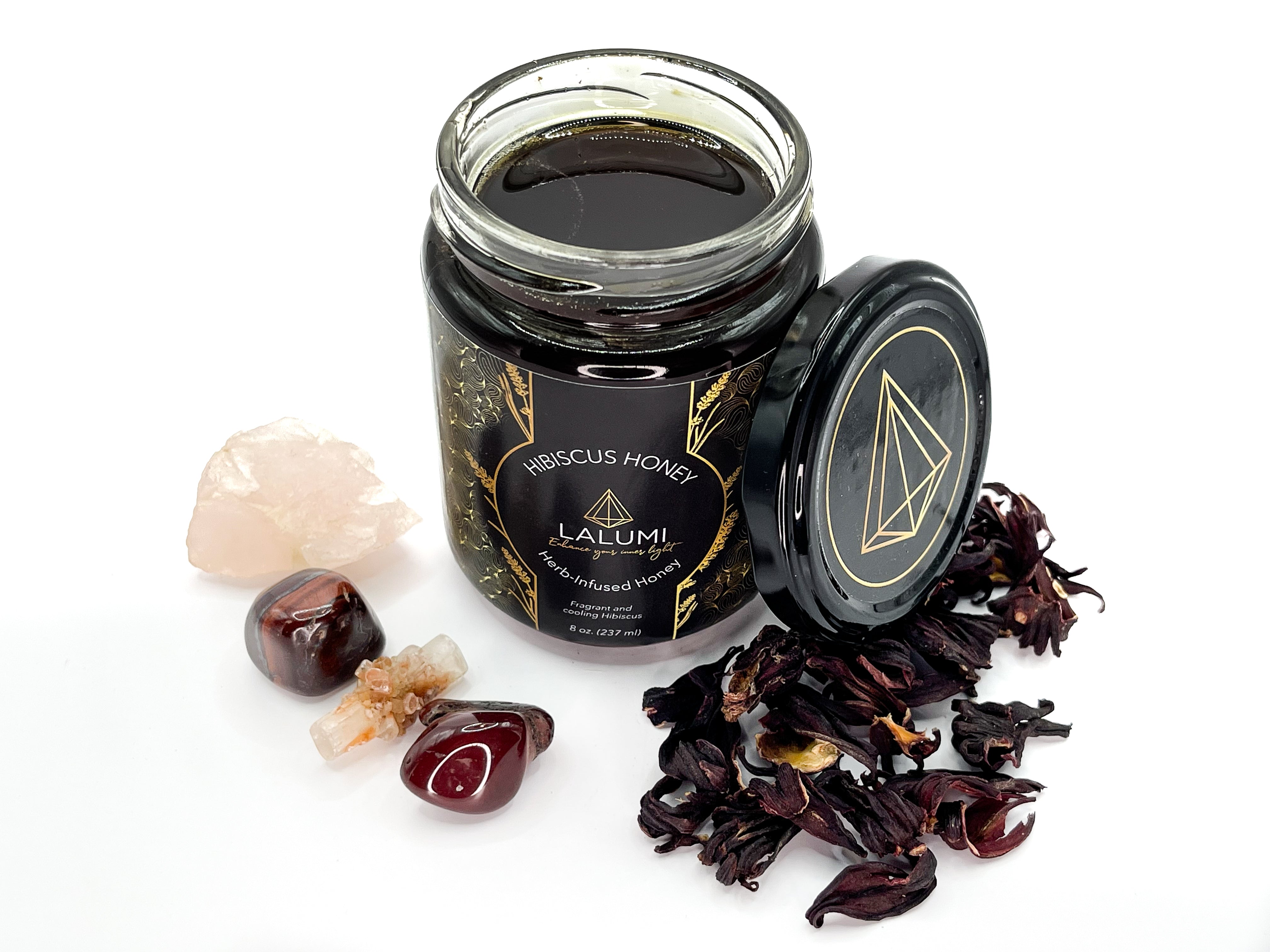 Image of Top view of 8 oz jar of Organic Hibiscus Infused Local Honey by LaLumi Herbes with ingredients on a white background