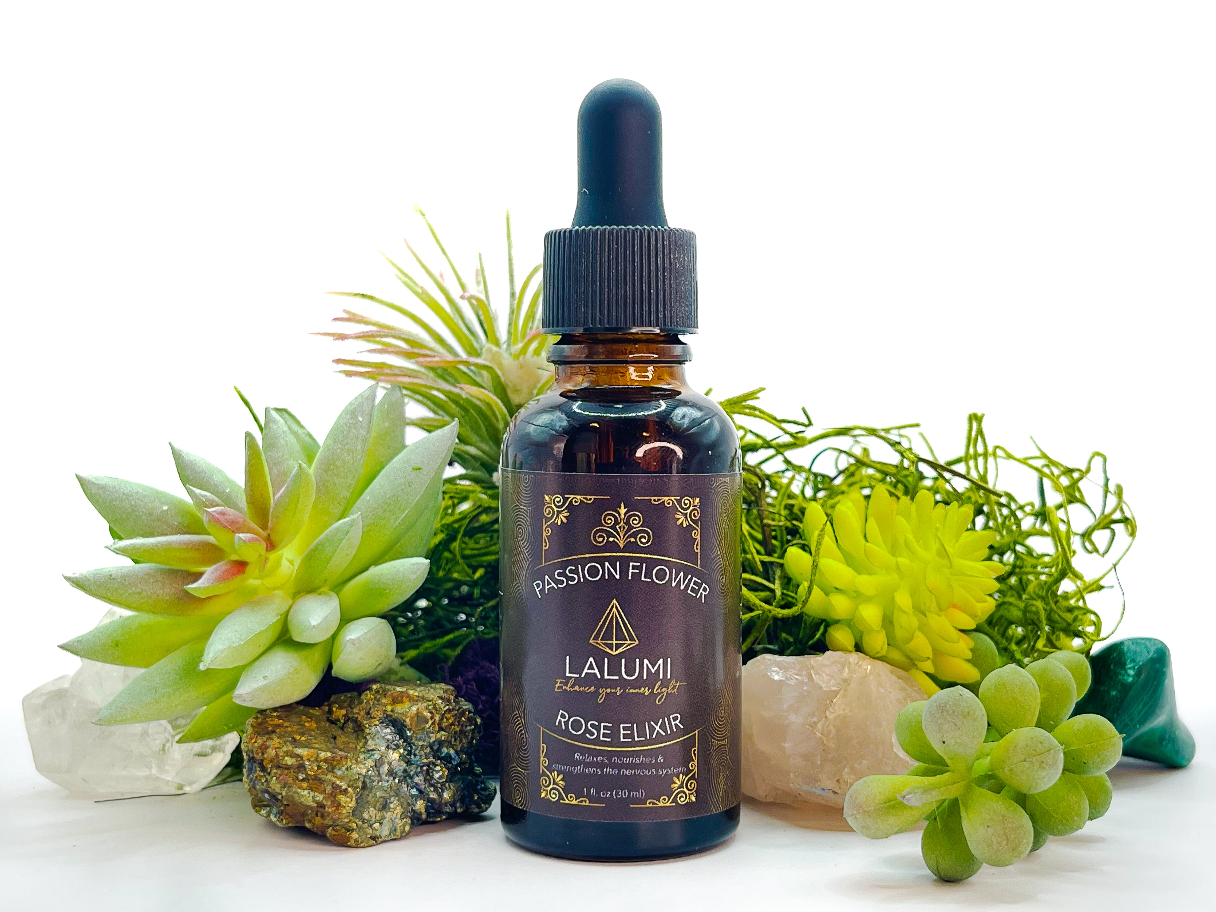 Image of 1 oz bottle of Wildcrafted Passionflower-Rose Herbal Elixir by LaLumi Herbes with succulents and crystals on a white background